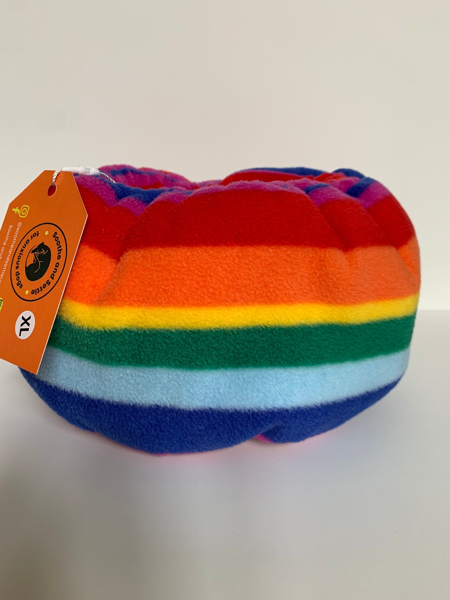 One rainbow dog snood with the tag on.
